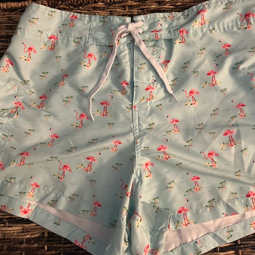 Green board shorts with pink flamingoes